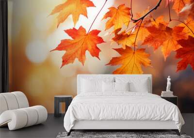 border of orange maple leaves on a branch with bokeh in the background, autumn vibes Wall mural