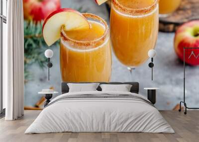 two caramel apple mimosas in champagne flutes, with a cinnamon-sugar rim and garnished with fresh apple slices Wall mural