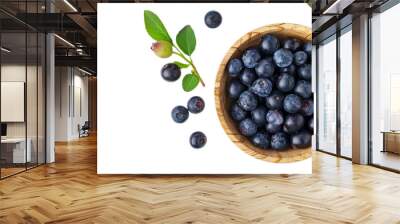 Top view of the blueberry in wooden bowl with green leaves, healthy berry fruit. Wall mural