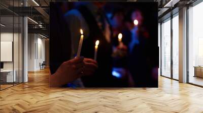 People hold candles light at dark scene Wall mural