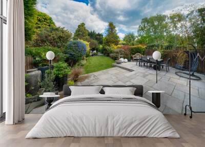 Beautiful summer garden in England, UK with lawn and large indian sandstone patio. Wall mural