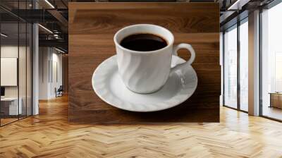 Dark coffee in white mug on wooden table.. Wall mural