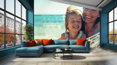 mother and daughter laughing together in the hammock on summer beach, having fun at vacation by sea Wall mural