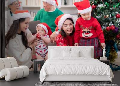 A joyful moment for a large family celebrating together at home during the Christmas season Wall mural