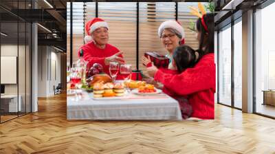 Family members gather to enjoy a meal together during the Christmas holiday at home Wall mural