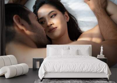 Gorgeous sexy couple enjoying arousing sex before having sex on bed in home bedroom The concept of emotional and love relationships. Wall mural