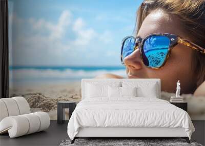 Young woman relaxing on the sandy beach under the sunny sky with ocean waves in the background Wall mural