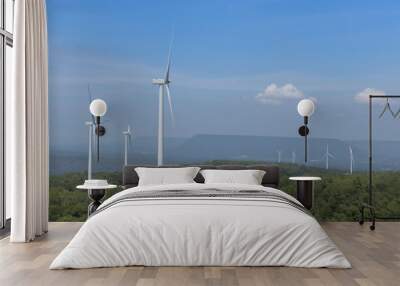 Mountain wind turbines for generating electricity Behind the mountains in the sky, there are white clouds on a sunny day. Wall mural