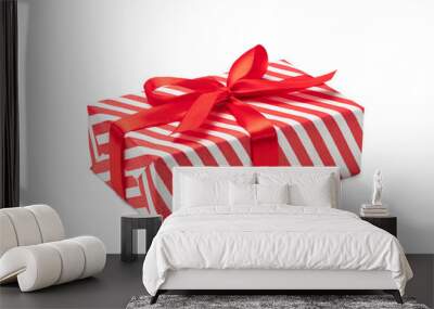 Close up shot of present box wrapped in red and white striped paper and decorated with a bow, isolated on white background Wall mural