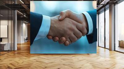 Business partners confidently shaking hands, symbolizing collaboration and success in a professional environment. Wall mural