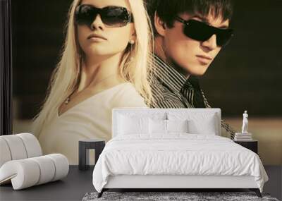 Happy young fashion couple in sunglasses Wall mural