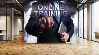 businessman is pressing on the virtual screen and selecting online training. Wall mural