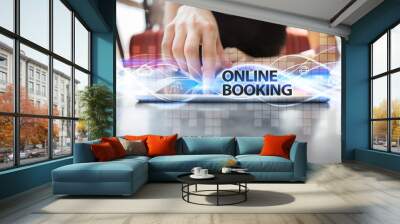 Woman using tablet pc and selecting online booking. Wall mural