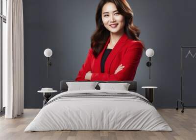 A confident professional businesswoman poses with her arms crossed against a white studio background. Wall mural