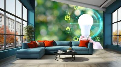 Hands preserving a green tree globe on a tropical nature summer background, Ecology and Environment concept, Energy saving light bulb and save the world concept, sustainable development Wall mural