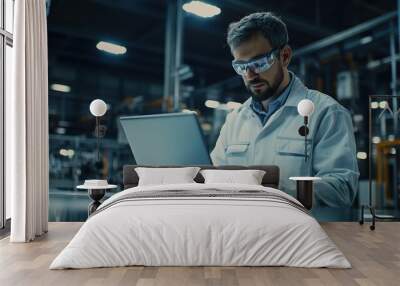 Industrial Engineer Working on Laptop in Factory Setting Wall mural