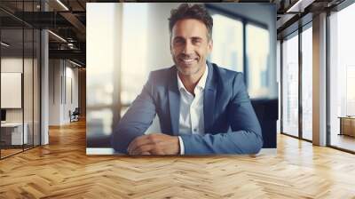 portrait of a businessman sitting on his desk office and look at camera  Wall mural