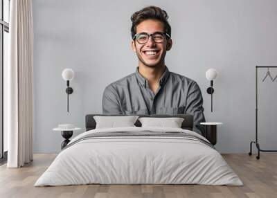 Portrait of young handsome smiling business guy wearing gray shirt and glasses, feeling confident with crossed arms, isolated on white background Wall mural