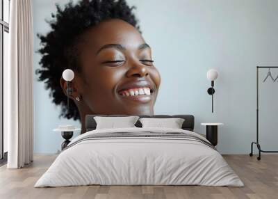 Pure Joy, Unleashed: A young Black woman radiates happiness with closed eyes and a bright smile, her fist clenched in a gesture of victory.  Wall mural