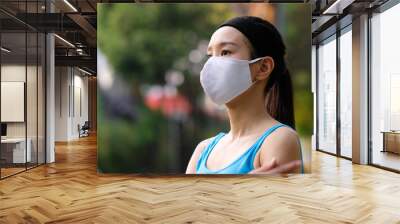 young woman in a mask for particulate matters and coronavirus protection Wall mural