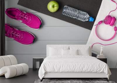 Sport and fitness accessories, healthy and active lifestyle concept on grey wooden floor background with copy space. Products with vibrant, punchy pastel colours. Image taken from above, top view. Wall mural