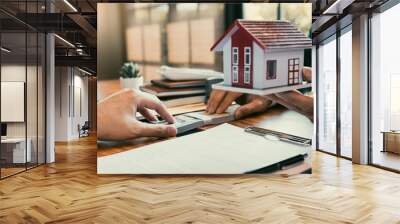 Investors are using st pen on the contract paper about buying a new home while filing cash as a deposit for the agent. Wall mural