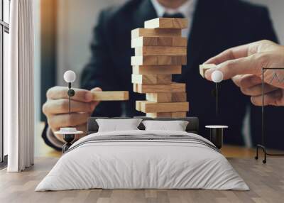 Strategic thinking and risk by business people pulls wooden blocks from the group. Wall mural