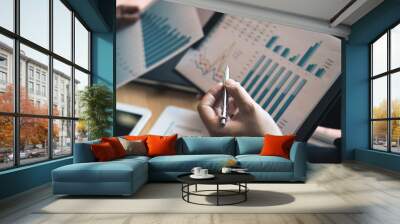 Two business partnership coworkers analysis strategy and gesturing with discussing a financial planning graph and company budget during a budget meeting in office room. Wall mural