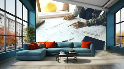 two engineering man standing examining working on blueprint. Wall mural