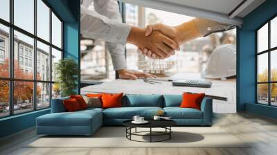 Two engineering man with construction worker greeting a foreman at renovating apartment. Wall mural