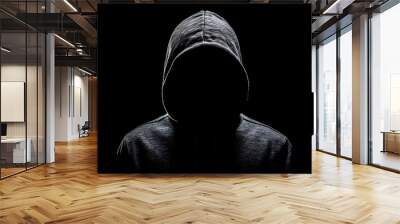 silhouette of a man with a hood on a black background, silhouette of an unidentifiable person wearing a hooded sweatshirt Wall mural