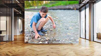 child playing on a river bank Wall mural