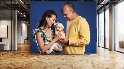 Happy family with baby daughter Wall mural