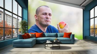 Man eating an apple outdoor Wall mural