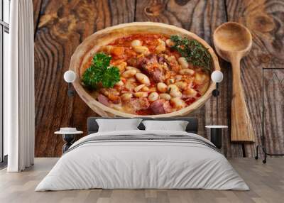 Smoked pork and beans stew on a rustic table Wall mural