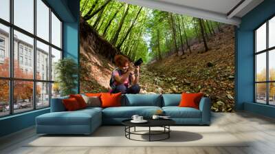 Woman professional nature photographer in the forest Wall mural