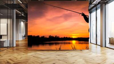 A solitary woman is depicted during sunset, fishing at night by a lake. The silhouette evokes an intimate, romantic and calm image. Generative AI Wall mural