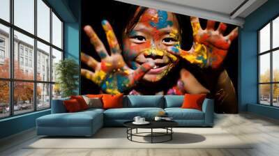 Cambodian girl with a look of delight, her hand covered in a kaleidoscope of paint, a dark backdrop highlighting the colors Wall mural