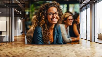 Diverse, empowered women in casual work attire joyfully brainstorming in a modern co-working space, embodying unity, creativity and the spirit of sisterhood. Wall mural