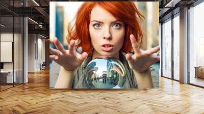 Futuristic vision with a baffled redhead seer against a silver backdrop, gazing in awe at the unexpected cityscape in her crystal ball. Generative AI Wall mural