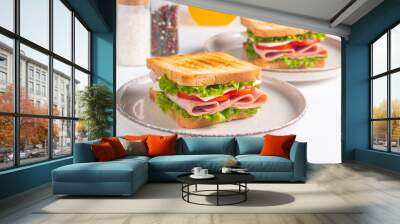 Close-up of two sandwiches with bacon, salami, prosciutto and fresh vegetables on rustic wooden cutting board. Club sandwich concept Wall mural