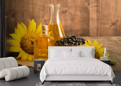 Closeup photo of sunflower oil with seeds on wooden background. Bio and organic product concept. Wall mural