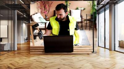 
Worker in his work area with a computer, gloves and a mallet hammer Wall mural