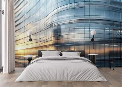 A building with a lot of glass windows and a sun setting in the background Wall mural