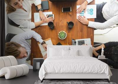 A team of young businessmen working and communicating together in an office. Corporate businessteam and manager in a meeting. Wall mural