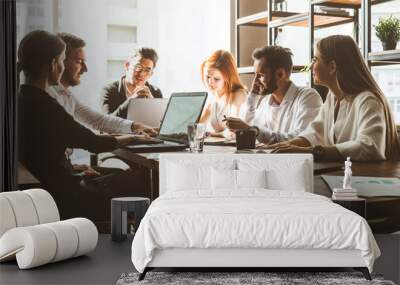 A team of young businessmen working and communicating together in an office. Corporate businessteam and manager in a meeting. Wall mural