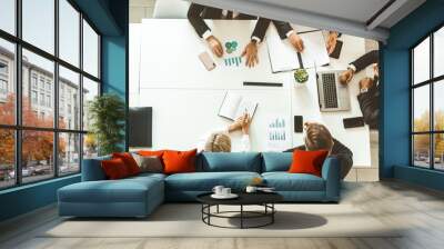 A team of young businessmen working and communicating together in an office. Corporate businessteam and manager in a meeting. Wall mural