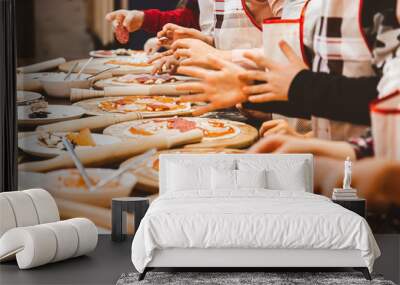 Children cook pizza. Master class from the chef in a restaurant, Close-up of children's hands roll out the dough Wall mural