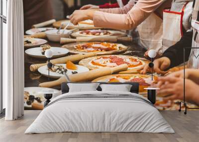 Children cook pizza. Master class from the chef in a restaurant, Close-up of children's hands roll out the dough Wall mural