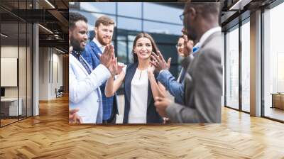 Portrait of an handsome businesswoman in front of his team. recognition, movement on the career ladder, success in business Wall mural